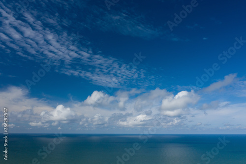 Peaceful sea and cloudy blue sky. Horizon line.