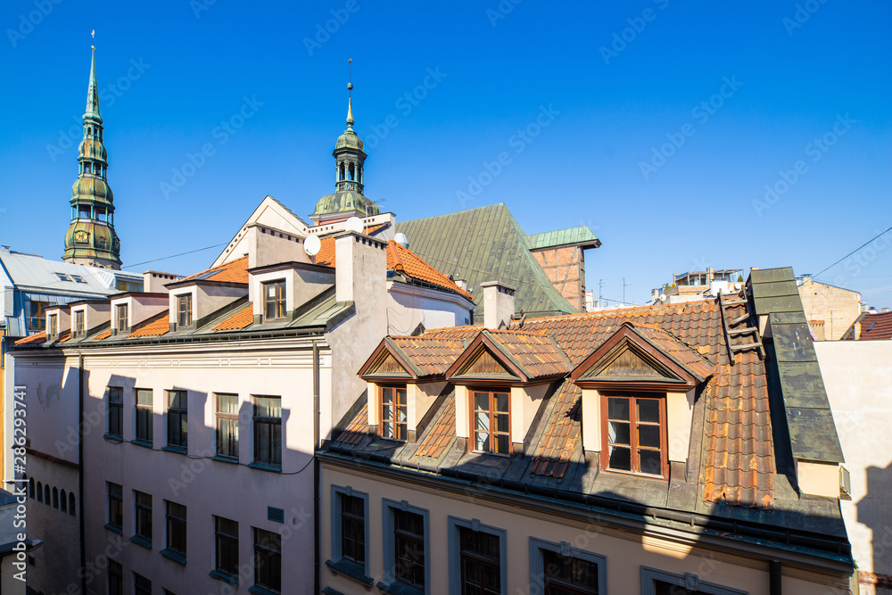 Old town in Riga. Attic windows on the roofs.
