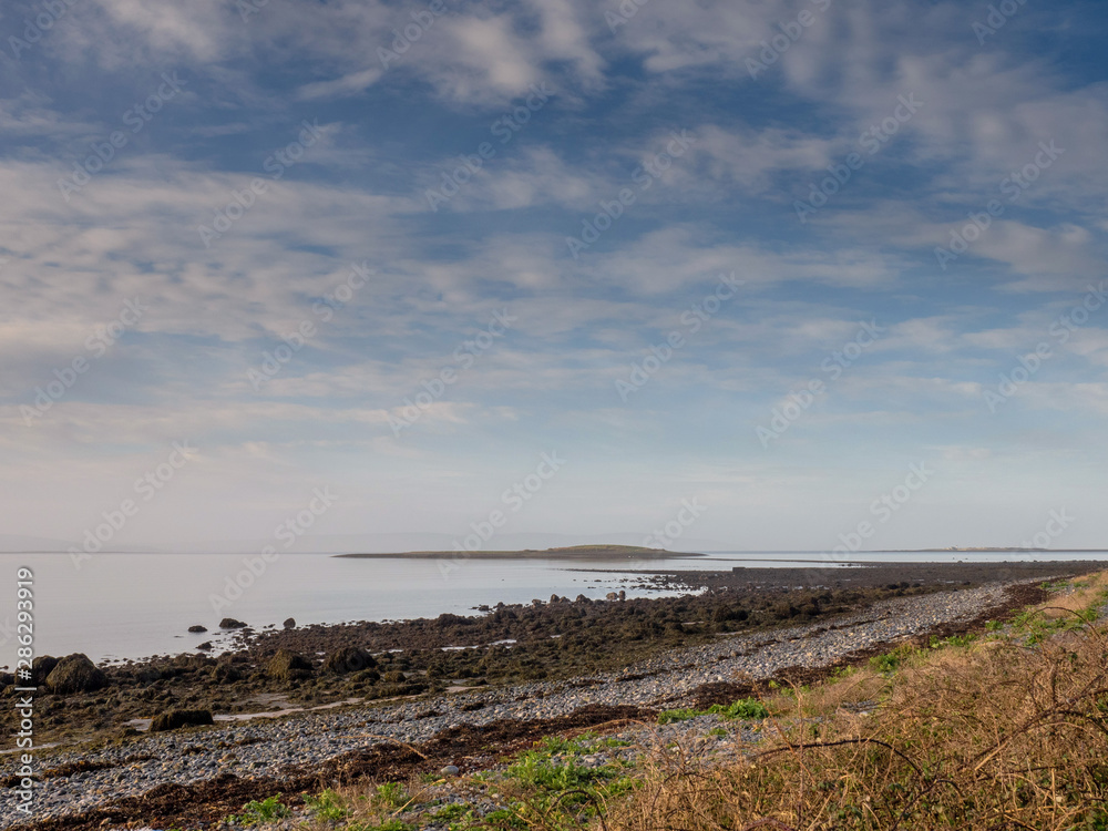 Galway bay, Atlantic ocean, Ireland, Hare Island, West coast of Ireland. Cloudy blue sky. Low tide. Galway bay, Atlantic ocean, Ireland, Hare Island, West coast of Ireland. Cloudy blue sky. Low tide.