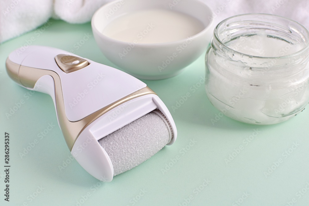 Electric foot file and natural products for feet care milk and coconut oil for softer skin Electric foot file and natural products for feet care milk and coconut oil for softer skin