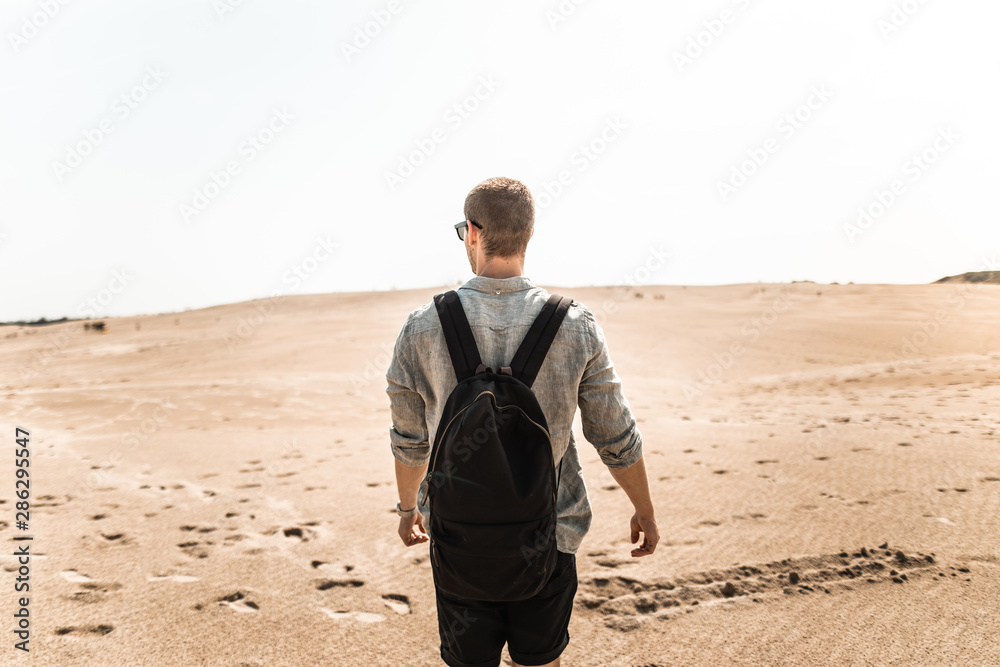 Male hiker in desert sand dunes off Denmark Skagen Male hiker in desert sand dunes off Denmark Skagen
