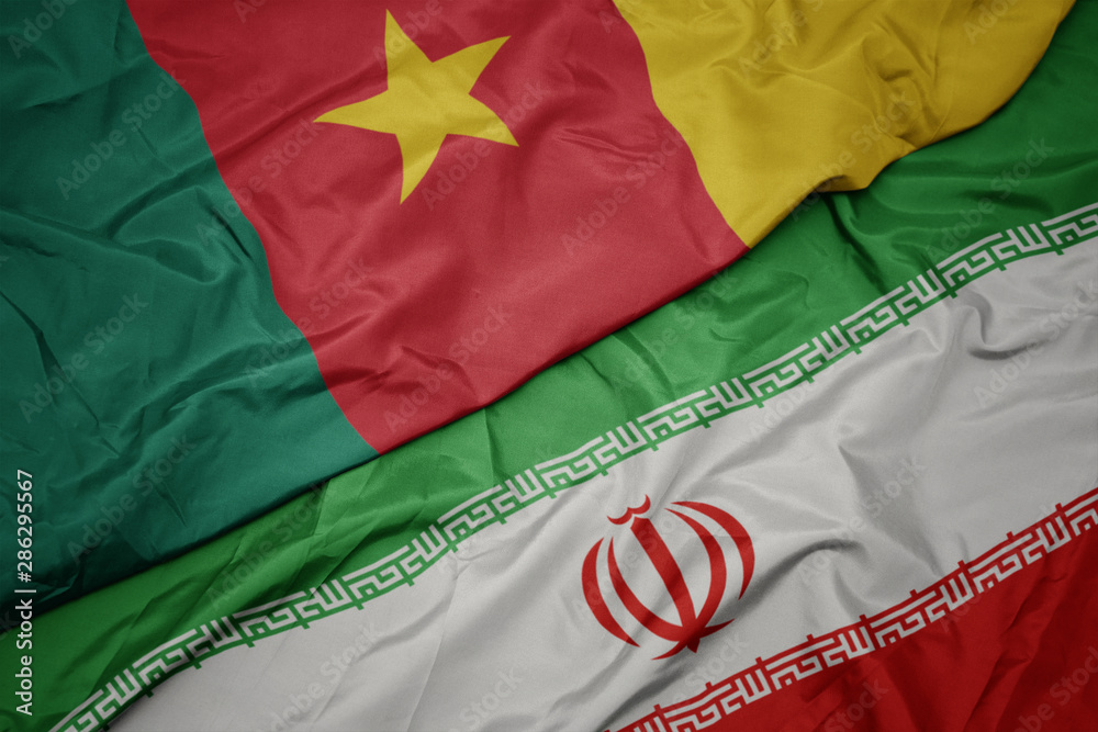 waving colorful flag of iran and national flag of cameroon.