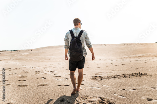 Male hiker in desert sand dunes off Denmark Skagen