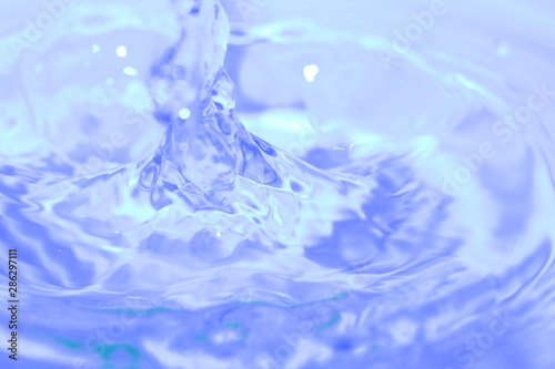 rings on the water surface, soft focus , motion blur. Close Up blue water rings, clear water, close-up water droplets affect the surface splash in the pool