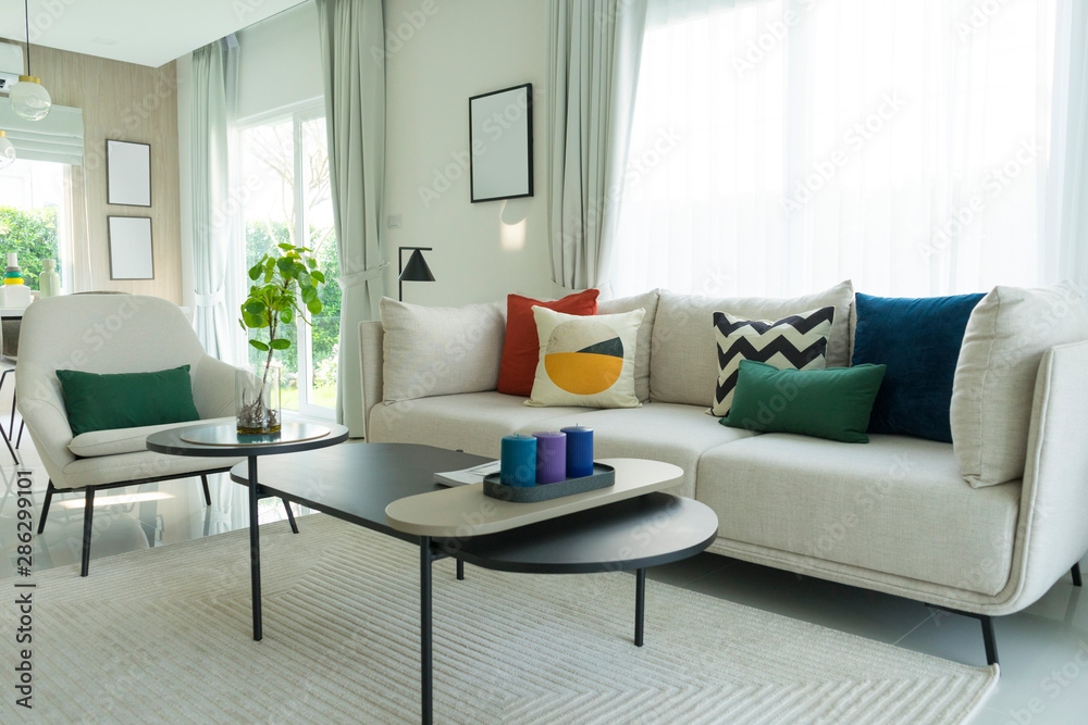 Large white sofa with colorful cushions in a spacious living room ...