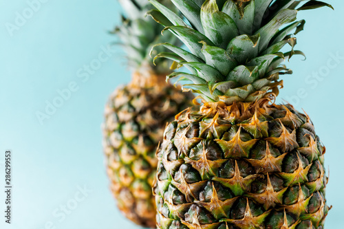 Two Pineapple fruit background. Close up of tropical pineapples texture. Summer, holiday concept. Selective focus.