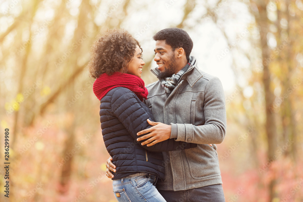 Love and relationship concept. Couple hugging in autumn park Love and relationship concept. Couple hugging in autumn park