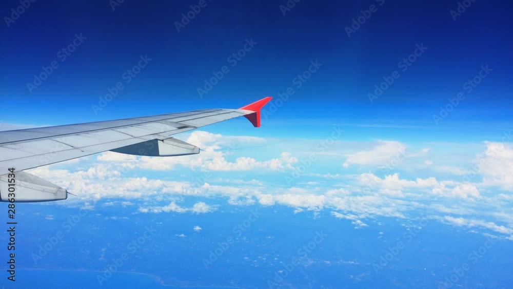 HD : Airplane wing and sky view from window on cloud HD : Airplane wing and sky view from window on cloud