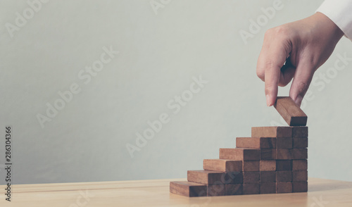 Hand arranging wood block s...