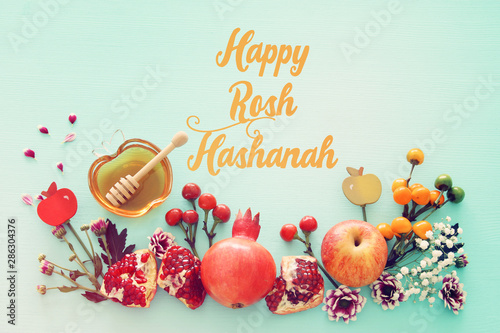 religion image of Rosh hashanah (jewish New Year holiday) concept. Traditional symbols over wooden mint blue pastel background