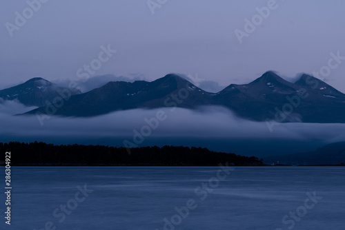 Landscape of mountains coming out from the sea in Molde, a beautiful view from of the fjord. © Daniel M