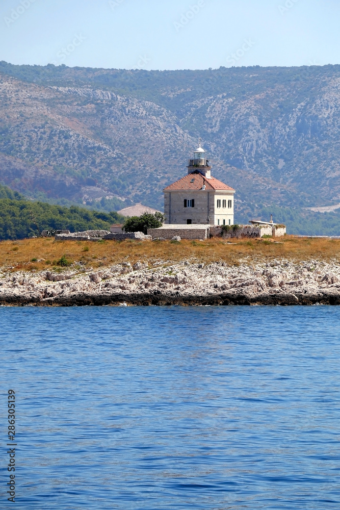 Picturesque lighthouse on a small island near town Hvar, on island Hvar, Croatia.