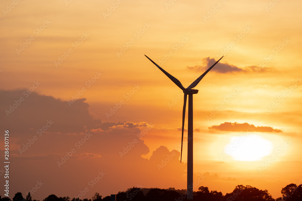 silhouette of wind turbine located on a ridge with wind blowing all the time. Making it able to effectively produce renewable electricity, which is another clean energy. silhouette of wind turbine located on a ridge with wind blowing all the time. Making it able to effectively produce renewable electricity, which is another clean energy.