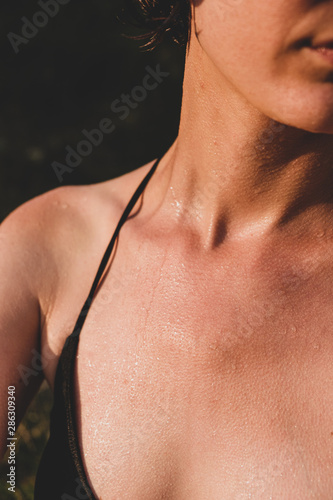 Wallpaper Mural Female skin wet and with goosebumps from swimming in cold water. Close-up view of female sitting in the evening sun after taking a swim Torontodigital.ca