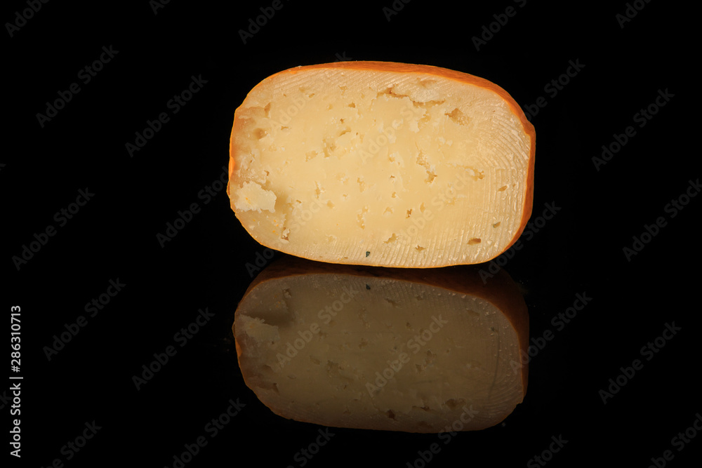 half of hard porous yellow edam cheese head with holes half of hard porous yellow edam cheese head with holes