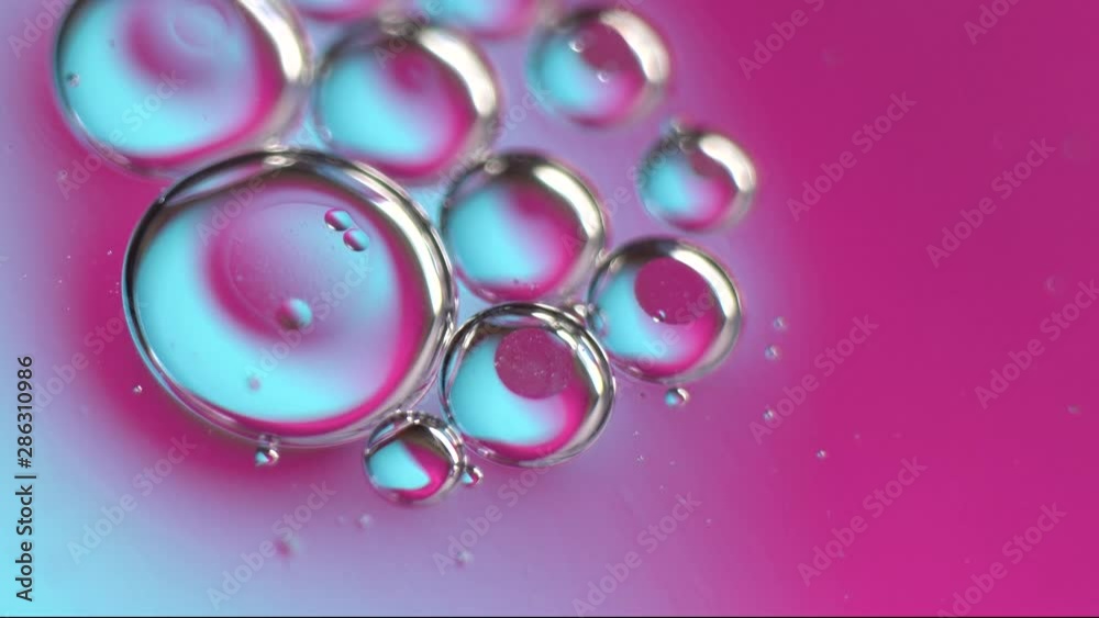 Neon ultraviolet and blue gradient. Macro oil drop in water. Holographic bubbles Neon ultraviolet and blue gradient. Macro oil drop in water. Holographic bubbles