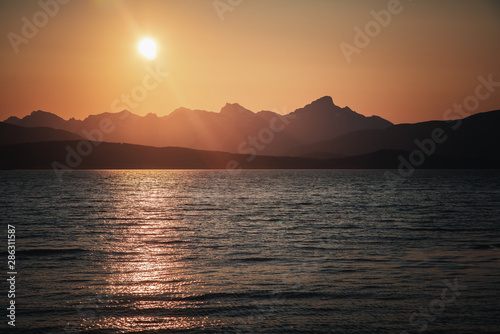Midnight sun and sunset colors on the beach on the Tromso coast in Norway