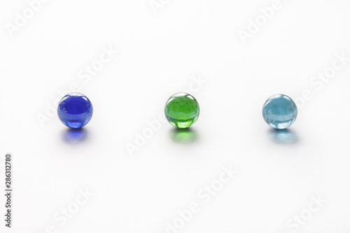 Glass colored balls on a white background. Abstract background. Shallow depth of field (DOF)