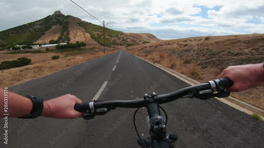 POV of cyclist racing downhill on mountain bike POV of cyclist racing downhill on mountain bike
