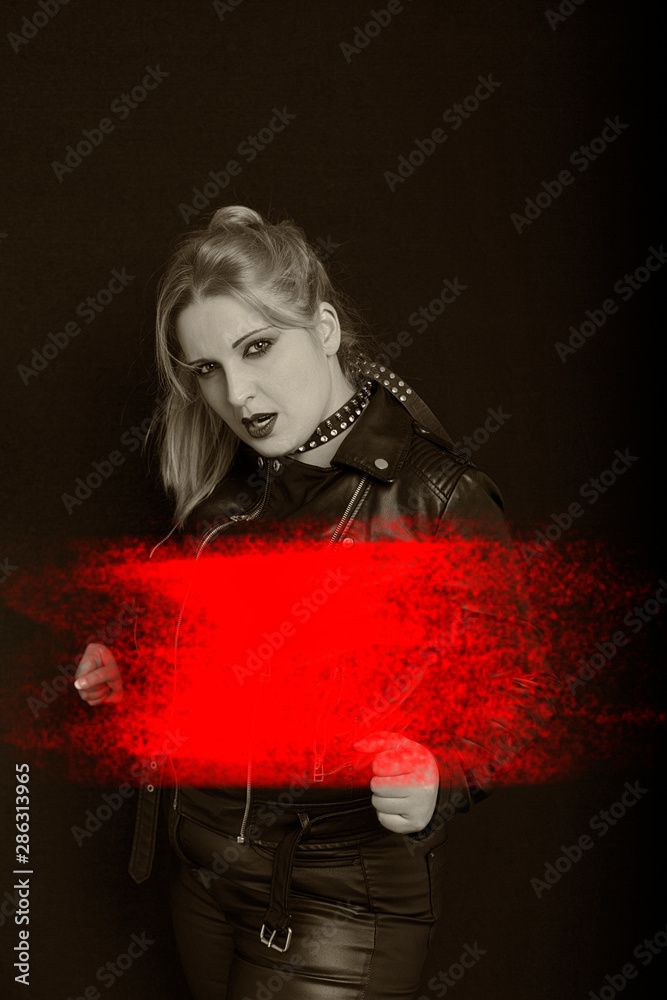 Beautiful blonde girl in rock style on a black background. Beautiful blonde girl in rock style on a black background.