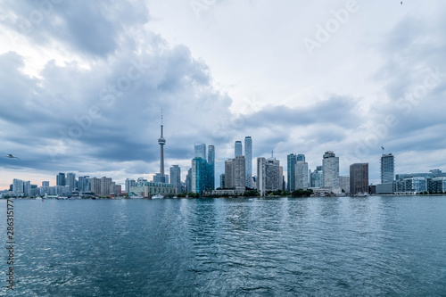 Waterfront view of Toronto City Skyscrapers along with CN Tower  Scarborough districts in summer  a view from Toronto Central Island  Toronto  Ontario  Canada