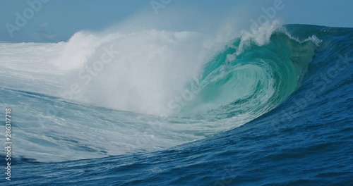 SLOW MOTION: Epic blue wave breaking and barreling with lots of white water, raw natural wonder
