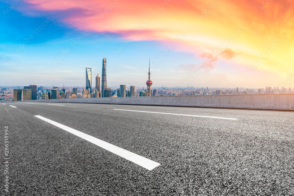 Empty highway and modern city skyline at sunset in Shanghai,China.