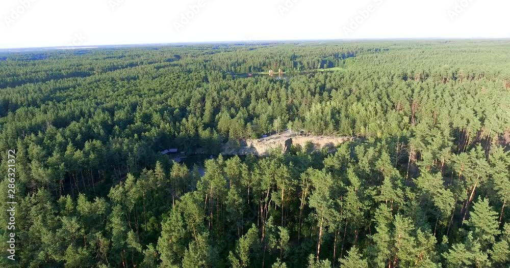 Aerial View. Lake with turquoise water and pine trees. Beautiful landscape flooded quarry in pine forest. Aerial View. Lake with turquoise water and pine trees. Beautiful landscape flooded quarry in pine forest.