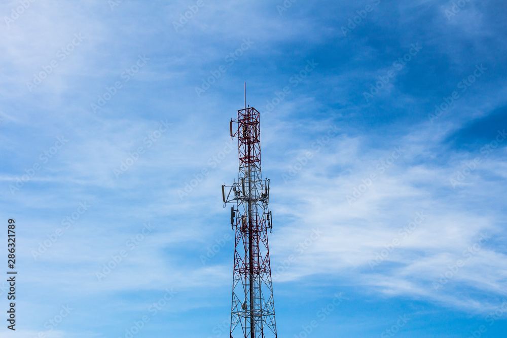 tower of communications with a lot of different antennas under beautiful sky.