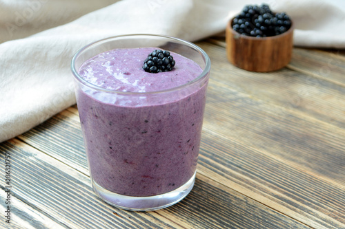 Delicious smoothie with organic blackberries in a transparent glass Healthy eating concept