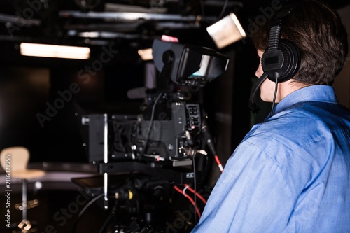 Camera Operator Filming in a Studio
