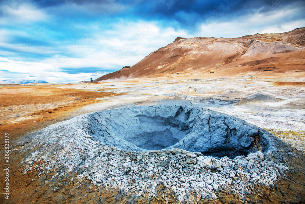 Magical dramatic scene with geothermal swamp and volcanoes in Hverir (Hverarond) valley in the Myvatn region. Iceland. Exotic countries. Amazing places.