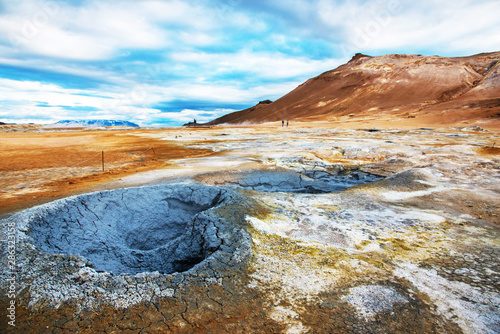 Magical scene with geothermal swamp and volcanoes  in Hverir (Hverarond) valley  in the Myvatn region. Iceland. Exotic countries. Amazing places. photo