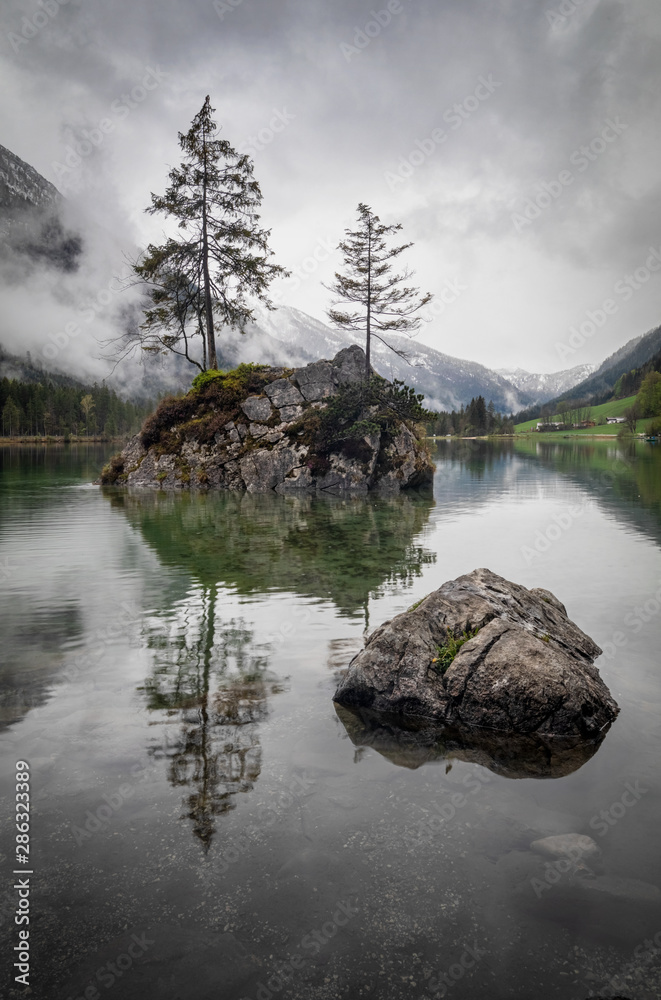 Misty summer morning on the Hintersee lake in German Alps