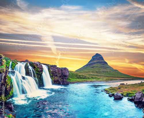 Fototapeta Naklejka Na Ścianę i Meble -  Beautiful natural magical scenery with a waterfall Kirkjufell near the volcano in Iceland. Exotic countries. Amazing places. Popular tourist atraction. (Meditation, antistress - concept).