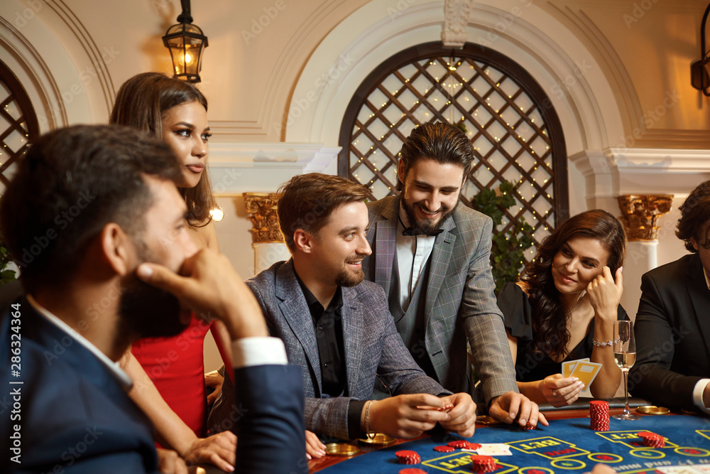 A group of people playing gambling in a casino