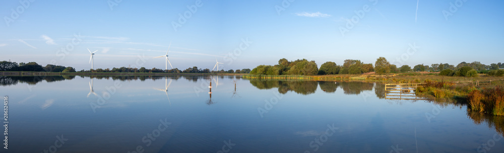 Pen-y-fan pond in Blackwood, Wales UK which has 3 wind turbines nearby