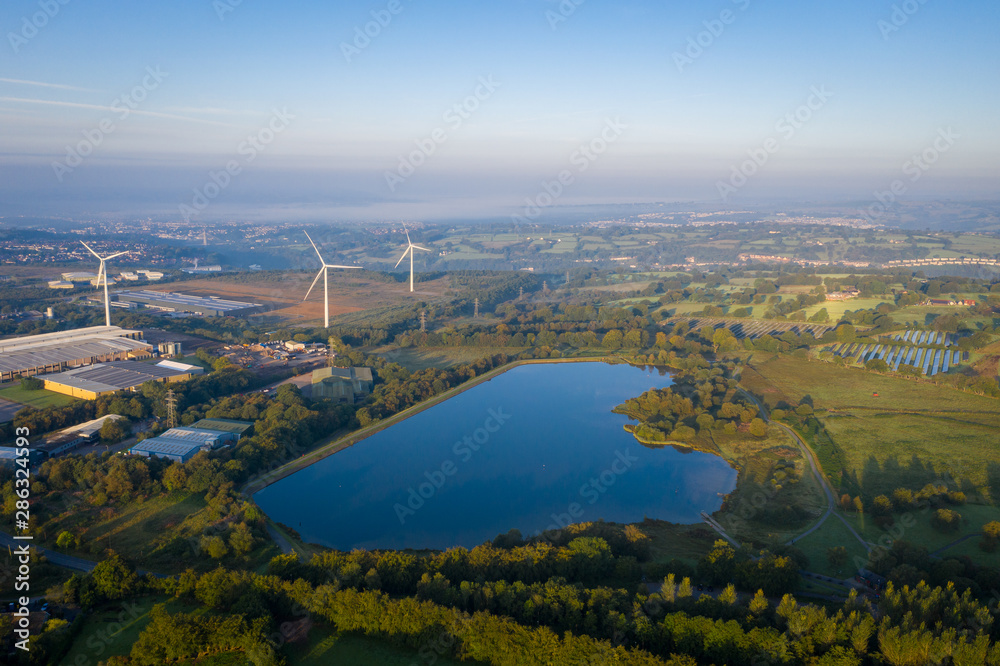 Pen-y-fan pond in Blackwood, Wales UK which has 3 wind turbines nearby