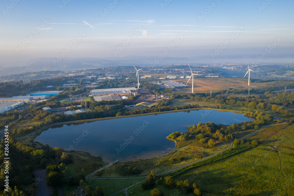 Pen-y-fan pond in Blackwood, Wales UK which has 3 wind turbines nearby