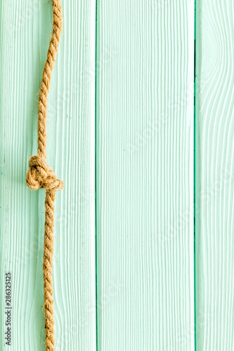rope frame on mint green wooden background top view mock-up