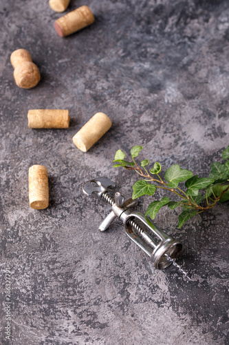 Exquisite vintage corkscrew for wine on a textural background. Copy space. Place for your text.