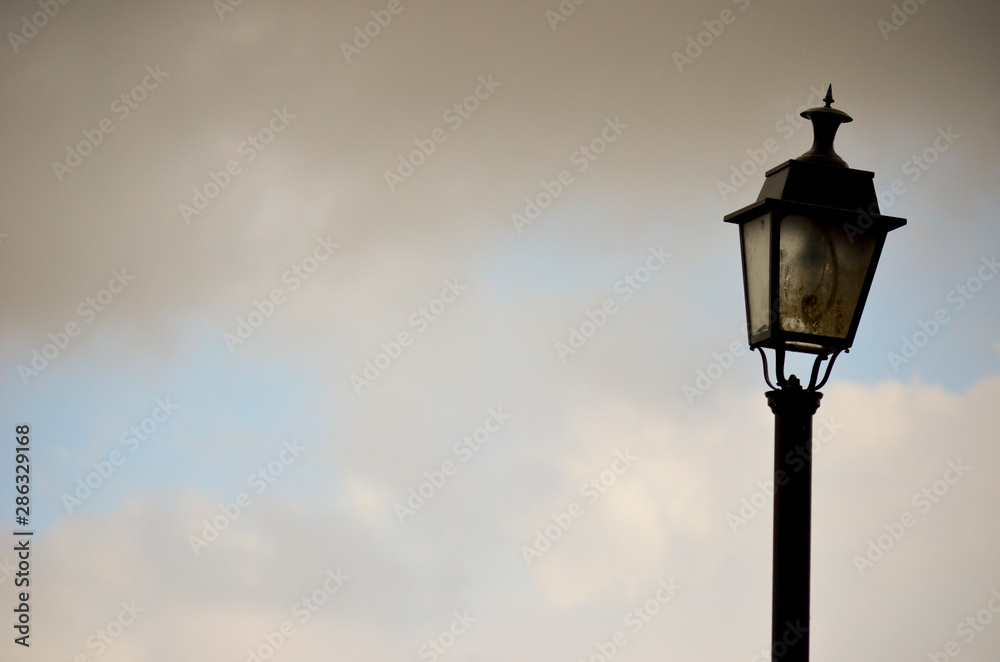 Isolated black lantern with the sky and clouds behind