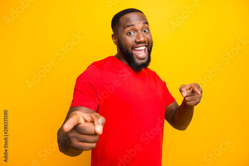 Photo of excited black man pointing at you with two forefingers while isolated with yellow background