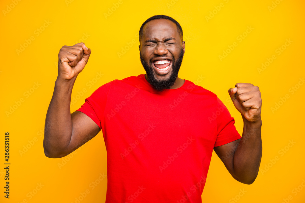 Photo of bearded overjoyed ecstatic man having won some competitions while isolated with yellow background Photo of bearded overjoyed ecstatic man having won some competitions while isolated with yellow background