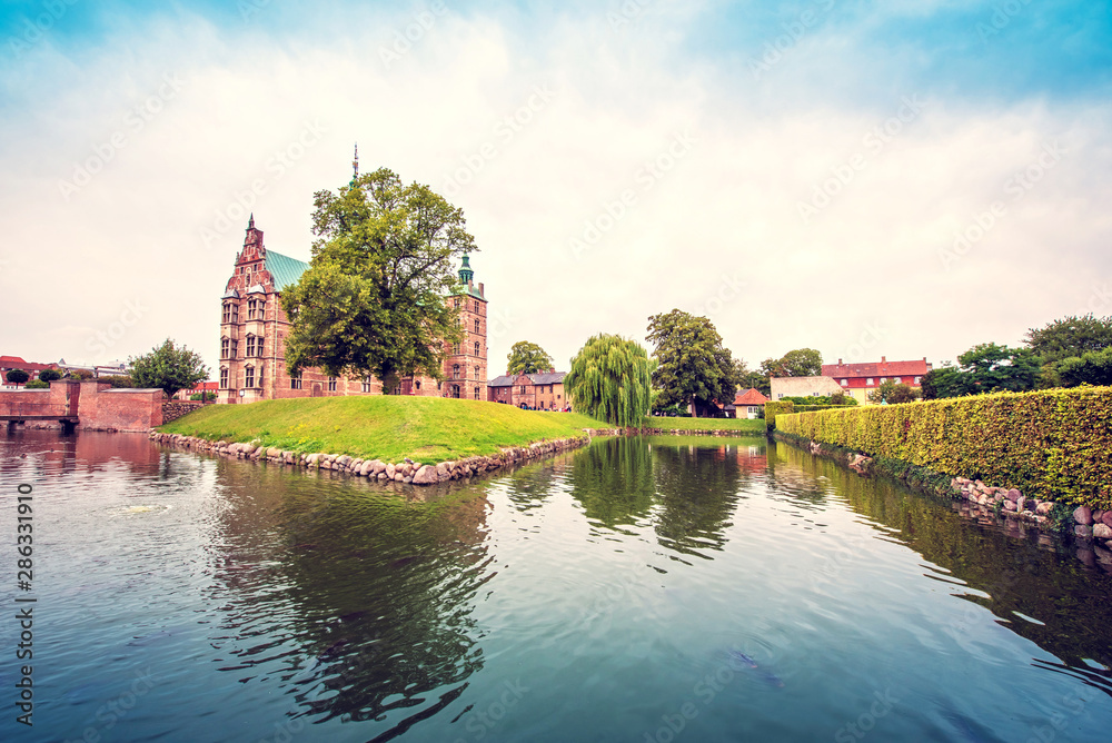 magical fascinating landscape with famous Rosenborg Castle near pond in palace garden in Copenhagen, Denmark. Exotic amazing places. Popular tourist atraction.