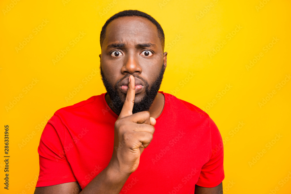 Close up photo of sad unhappy man who showing you that there is no need in talk while isolated with yellow background Close up photo of sad unhappy man who showing you that there is no need in talk while isolated with yellow background