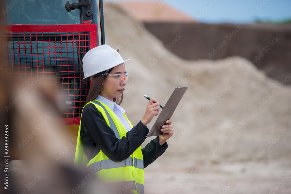 Asian engineer working at site of a large building project,Thailand people,Work overtime at construction site Asian engineer working at site of a large building project,Thailand people,Work overtime at construction site
