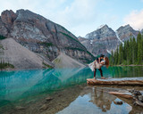 Couple kissing in the mountains by a lake