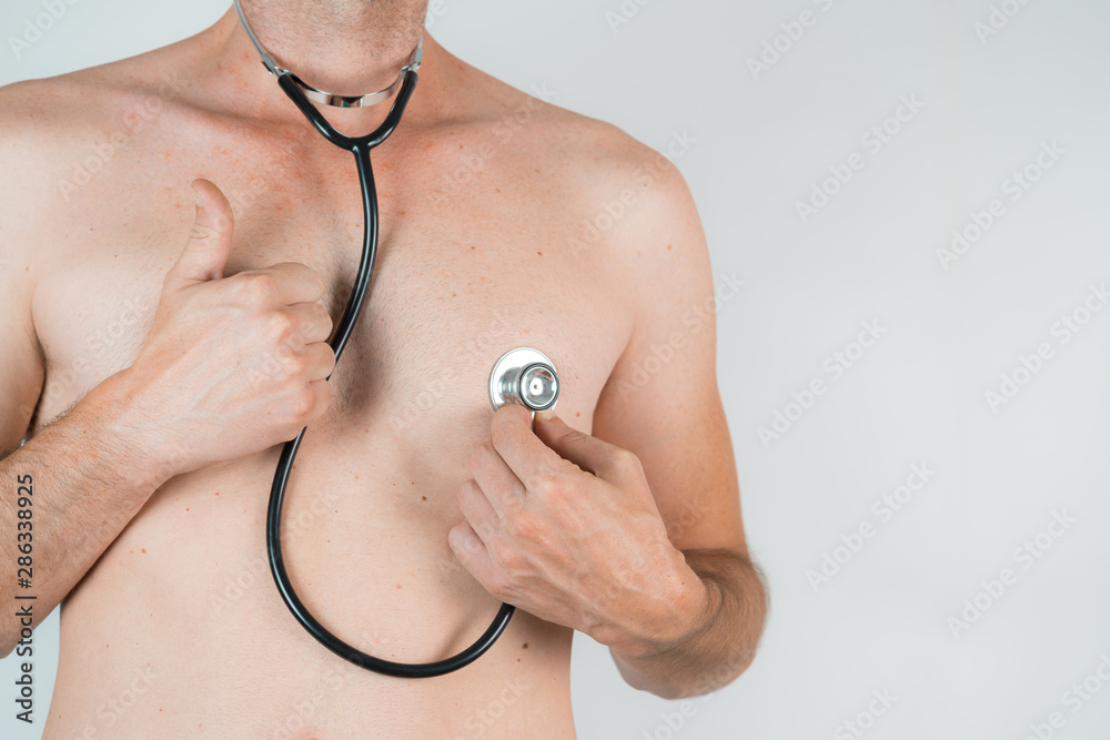 Fototapeta premium shirtless man with stethoscope and thumb up on White background