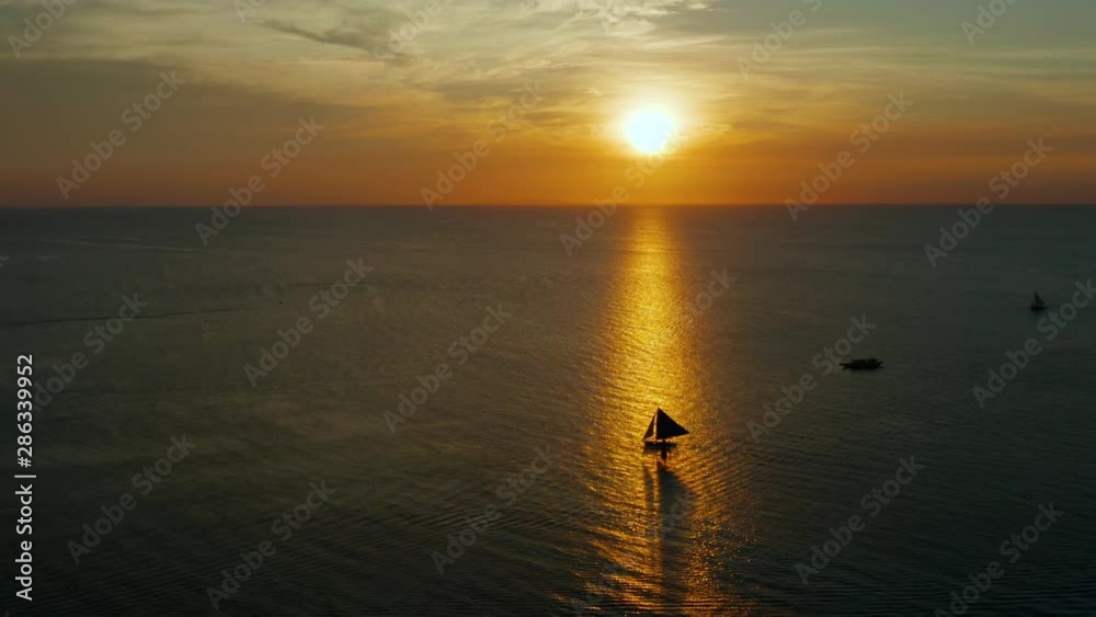 Colorful sunset above the sea surface with sailing yachts, aerial view Boracay, Philippines. Reflected sun on a water surface. Sunset over ocean. Seascape, Summer and travel vacation concept Colorful sunset above the sea surface with sailing yachts, aerial view Boracay, Philippines. Reflected sun on a water surface. Sunset over ocean. Seascape, Summer and travel vacation concept